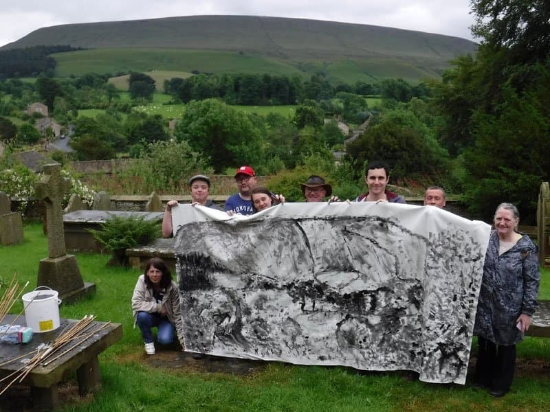 People holding large drawing