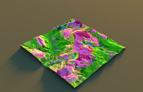 A 3D map of a hilly landscape. The higher ground is pink and purple, with lower ground in yellow, green and brown. It's quite neon coloured. We're looking at a hilly landscape going up the middle of the image, with a fairly deep valley to the left and undulating landscape on the right.